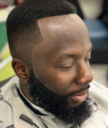 Full beard shaped with a high skin fade and sharp lineup